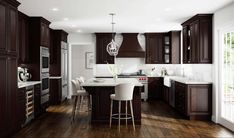 a large kitchen with dark wood cabinets and white counter tops, along with bar stools