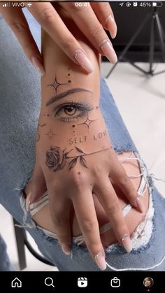 a woman's hand with tattoos on it