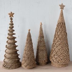 three small christmas trees made out of jute twine and burlocks on a table