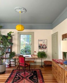 a living room filled with furniture and a large rug on top of a hard wood floor