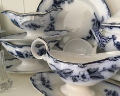 blue and white dishes are stacked on top of each other