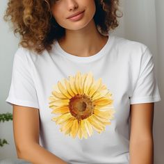 Yellow Sunflower Tshirt: Welcome to our blooming collection of floral-inspired shirts, where every petal whispers tales of elegance and charm. Embrace nature's beauty with our handcrafted designs, perfect for adding a touch of botanical bliss to your wardrobe. Crafted from our BELLA AND CANVAS brand, this tee offers style and comfort. Here's what you need to know before you make your purchase: * Unisex Adult Sizing. * Rolled Sleeves in pictures are for styling purposes only. * Props used in photos are NOT included with purchase. PRINT DESIGN * This is a Direct-To-Garment printed item, ensuring durability without cracking or peeling. * The ink is printed INTO the fabric, ensuring longevity. WASHING INSTRUCTIONS * Wash inside out, in cold water, on a gentle cycle. Tumble dry low or let air d Sunflower Tshirt, Women Nature, Minimalist Shirts, Botanical Shirt, Rolled Sleeves, Yellow Sunflower, Shirts For Women, Floral Shirt, Favorite Shirts