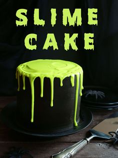 there is a cake that has been decorated with neon green icing and the words slime cake on it