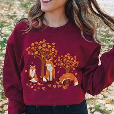 Cute foxes tree leaves sweatshirt is a great addition to any nature lovers and fox lover's wardrobe this season. Beautiful fall scene and fox makes this sweat shirt truly adorable to wear on any occasion. This vintage cottagecore sweater makes a great gift for mom, gift for grandma, gift for a friend, gift for a daughter, gift for nature lover, gift for fox lovers, fall gifts.  OUR ADULT SWEATSHIRTS Our designs are printed on a heavy blend crewneck unisex sweatshirt made out of a combination of Cozy Fall Sweatshirt Gift, Cozy Sweatshirt For Fall Gift, Cozy Fall Sweater Gift, Cozy Sweater For Fall Gift, Cozy Sweatshirt For Fall, Crew Neck Sweater For Fall - Great As Gift, Crew Neck Sweater As Fall Gift, Cotton Sweater As Fall Gift, Cotton Sweater For Fall, Perfect As A Gift