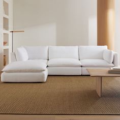 a white couch sitting on top of a carpeted floor