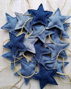 several blue and white stars are hanging from twine