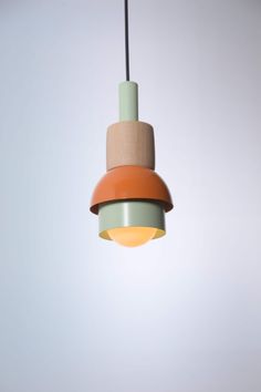 an orange and green light hanging from a ceiling