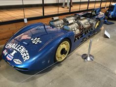 an old race car is on display in a museum