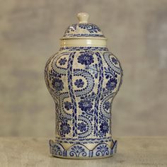 a blue and white vase sitting on top of a table