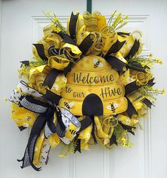 Bee hive Wreath For Front Door, Summer Wreath, Bee Door hanger, Wedding Gift, Summer decor, Housewarming gift, Grapevine wreath. This wreath is made on a wreath frame with 2 deco mesh, bow, 5 ribbon, flowers and a metal welcome to our hive sign. Measures approximately 24" x 24" x 6" Bee Hive Wreath, Bee Door Hanger, Welcome To Our Hive, Hanger Wedding, Wreath Frame, Bee Decor, Sunflower Wreaths, Welcome To, Front Door Wreath