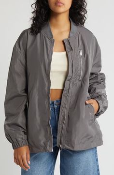 This lustrous bomber jacket is perfect for keeping you cozy during the cooler seasons with handy pockets, a drawstring hem and a ribbed blade collar. 27" length (size medium) Front zip closure Blade collar Elastic cuffs Chest zip pocket; front snap-flap pockets Drawcord-toggle hem 100% polyester Machine wash, dry flat Imported Trendy Outerwear With Side Pockets, Fall Nylon Track Jacket With Zipper Closure, Nylon Track Jacket With Zipper Closure For Fall, Fall Nylon Track Jacket With Ribbed Cuffs, Nylon Track Jacket With Ribbed Cuffs For Fall, Gray Outerwear With Side Pockets For Spring, Spring Gray Outerwear With Side Pockets, Gray Spring Outerwear With Side Pockets, Solid Track Jacket With Zipper Closure For Fall