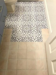 a bathroom with a toilet, sink and tiled floor