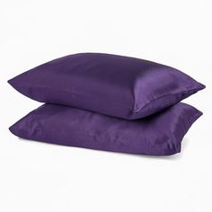 two purple pillows sitting next to each other on top of a white surface with the words lavender