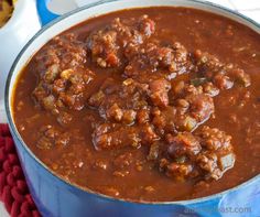 a blue pot filled with chili and meat