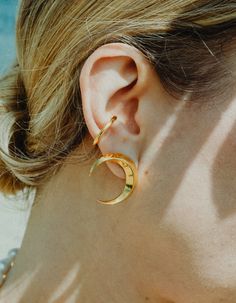 Symmetrical moon-shaped earrings made of sterling silver or sterling silver plated with 24 ct gold. Motif diameter: 24 mm. Decorative engraving on the reverse.We observe the phases of the Moon on Earth trying to solve the mystery of lunar attraction, but one side of this peculiar celestial body is always hidden in the shade of the Sun. Moon Phases Earrings, Gold Crescent Earrings With Moon Phase Detail, Celestial Half Moon Single Earring, Gold Moon Phase Earrings, Modern Crescent Jewelry For Pierced Ears, Modern Crescent Earrings, Silver Crescent-shaped Gold-plated Jewelry, Silver Crescent-shaped Gold Plated Jewelry, Gold-plated Silver Crescent Jewelry