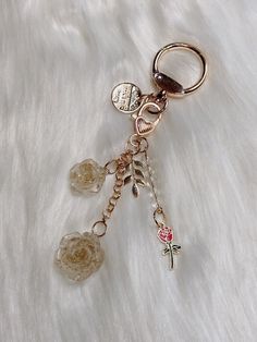 a close up of a keychain on a fur surface with beads and charms