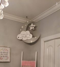 a child's room with a white rocking chair and stars on the wall above it