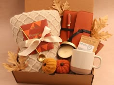 a box filled with coffee, candles and other things to make it look like fall