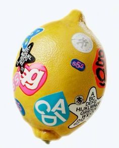 a close up of a lemon with stickers on it