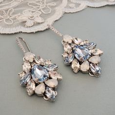 Elegant Vintage style Bridal Earrings. Made with high-quality Swarovski rhinestones in light blue and clear crystals, finished with elegant crystallized french hooks. Designed and created in SimplyChic studio Matching necklace available at this link: https://www.etsy.com/listing/782914818/sapphire-light-blue-statement?ref=shop_home_active_2&frs=1 Matching bracelet: https://www.etsy.com/listing/786999339/sapphire-light-blue-statement?ref=shop_home_active_43&pro=1&frs=1 Matching hair a Crystal Jeweled Chandelier Earrings For Wedding, Jeweled Crystal Earrings For Weddings, Blue Jeweled Earrings For Wedding, Wedding Crystal Jeweled Chandelier Earrings, Blue Crystal Earrings For Wedding, Elegant Blue Pierced Chandelier Earrings, Blue Rhinestone Crystal Earrings For Wedding, Elegant Light Blue Crystal Earrings For Gift, Glamorous Blue Chandelier Earrings