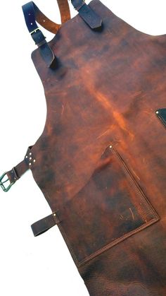 a brown leather apron with straps and buckles