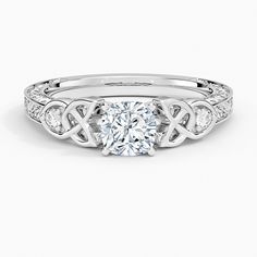 a white gold engagement ring with an intricate design