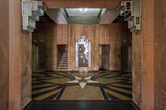 the interior of an old building with marble floors and wooden walls, decorated in art deco style