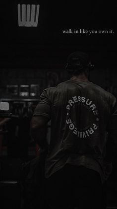 the back of a man wearing a shirt that says pressure grinds on it in white lettering