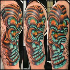 an image of a colorful tattoo design on the arm and leg, with a mask in the middle