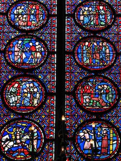 the large stained glass window is decorated with many different colors and shapes, including figures