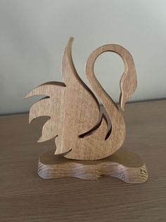 a wooden swan sculpture sitting on top of a table