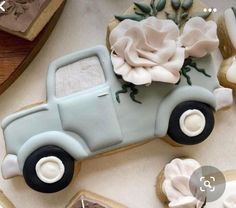 a cookie decorated like an old truck with roses on the front and back is shown