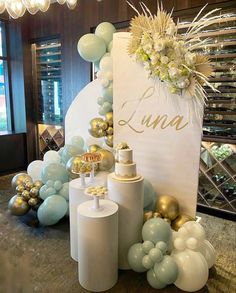 a table topped with balloons and cake next to a sign that says limoa on it