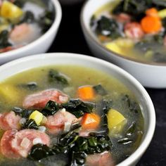 three bowls filled with soup and vegetables on top of a black countertop next to each other