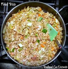 a pan filled with rice and vegetables on top of a stove