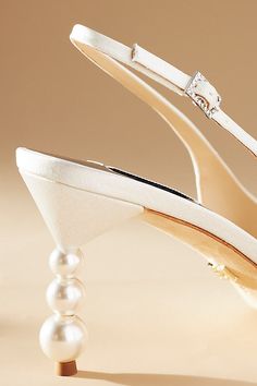 The Badgley Mischka Beatrix Slingback Pumps, adorned with an eye-catching stacked bubble heel, are ready to carry you through your special day in elegant style. | Beatrix Slingback Pumps by Badgley Mischka in White, Women's, Size: 7, Leather/Plastic/Wood at Anthropologie Slingback Pumps With Sculpted Low Heel For Wedding, Low Heel Slingback Pumps With Sculpted Heel For Wedding, Chic Slingback Pumps With Removable Insole For Wedding, Chic Low Heel Slingback Pumps For Wedding, Chic Wedding Slingback Pumps With Removable Insole, Elegant Party Heels With Pearl Handle, White Glamorous Slingback Pumps For Wedding, White Ankle Strap Slingback Pumps For Gala, Elegant Low Heel Slingback Pumps For Wedding