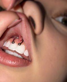 a close up of a person's mouth with an object in the middle