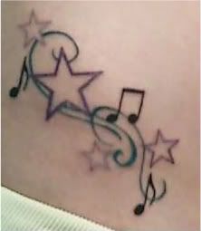 a tattoo with musical notes and stars on it