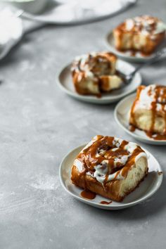 three white plates topped with desserts covered in caramel