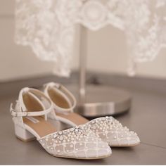 a pair of white shoes sitting on top of a table