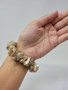 "Natural Sea Shell Bracelet. Puka Shell Bracelet - Stretch bracelet. This Seashell Bracelet is stretch. Beach Bracelet, Surfer Style. Hawaiian Design. This Shell Bracelet is perfect for Womens or Teens Handmade with 3/4\" Inch\" Hand-Selected High Quality Clam Shells. Fits Most Size. Stretch from 5\" Inches up to 6\" Inches. Around the wrist. FAST & FREE SHIPPING! Visit my Etsy Shop to see more Designs! Handmade Puka Necklaces, Bracelets and Earrings: https://www.etsy.com/shop/FreedomLifeSty Adjustable Shell Bracelet, Elegant Adjustable Shell Bracelet, Elegant Beige Beach Bracelet, Shell Strand Bracelets As Gift, Adjustable Shell Pearl Bracelet For Beach, Brown Bangle Bracelet For Beach, Elegant Shell Bracelet As A Gift, Brown Bangle Bracelet For The Beach, Shell Oyster Bracelet As Gift