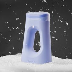 there is snow falling from the top of a plastic object