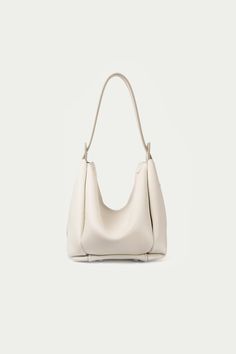 Advene | The Age Bag | Cream Chic Bucket-shaped Hobo Bag For On-the-go, Elegant Triangle Shoulder Bag For Daily Use, Elegant Triangular Everyday Bag, Elegant Everyday Triangle Bag, Modern Shopping Bucket Bag With Single Strap, Chic Hobo Bag For On-the-go In Bucket Shape, Chic Bucket Shape Hobo Bag For On-the-go, Chic Bucket Shaped Hobo Bag For On-the-go, Modern Bucket Bag With Single Shoulder Strap