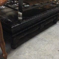 an old fashioned stove is sitting in the middle of a room with other antique furniture