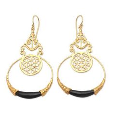 A tiny openwork circle hangs within a delicately crafted golden hoop in this exquisite pair of earrings from Made Nuada. Hand crafted from 18k gold-plated brass the earrings feature curling golden designs and a small but striking water buffalo horn accent at the bottom of the hoop. Golden Hoops, Golden Design, Water Buffalo, Henna Tattoo Designs, Bead Earrings, Henna Tattoo, Beaded Earrings, Horn, Henna