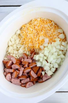 the ingredients for this meal are mixed together in a white bowl on top of a wooden table