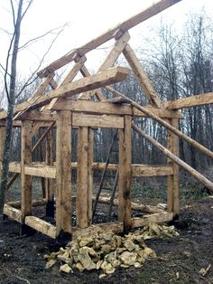 a wooden structure is being built in the woods