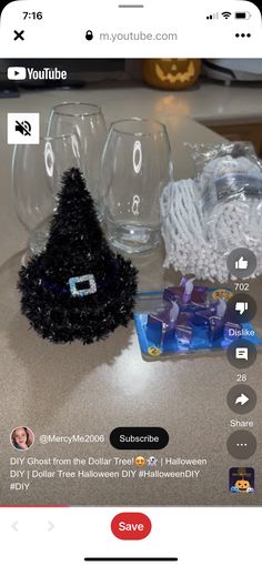 a table with some wine glasses and other items on it's side, including a fake christmas tree