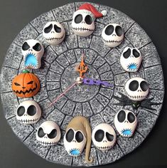 a clock made to look like skulls and pumpkins