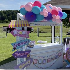 an ice cream cart decorated with balloons and buntings for a birthday party or baby shower